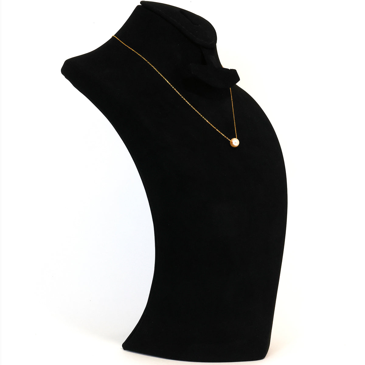 Black turtleneck sweater with a gold necklace on a mannequin against a white background