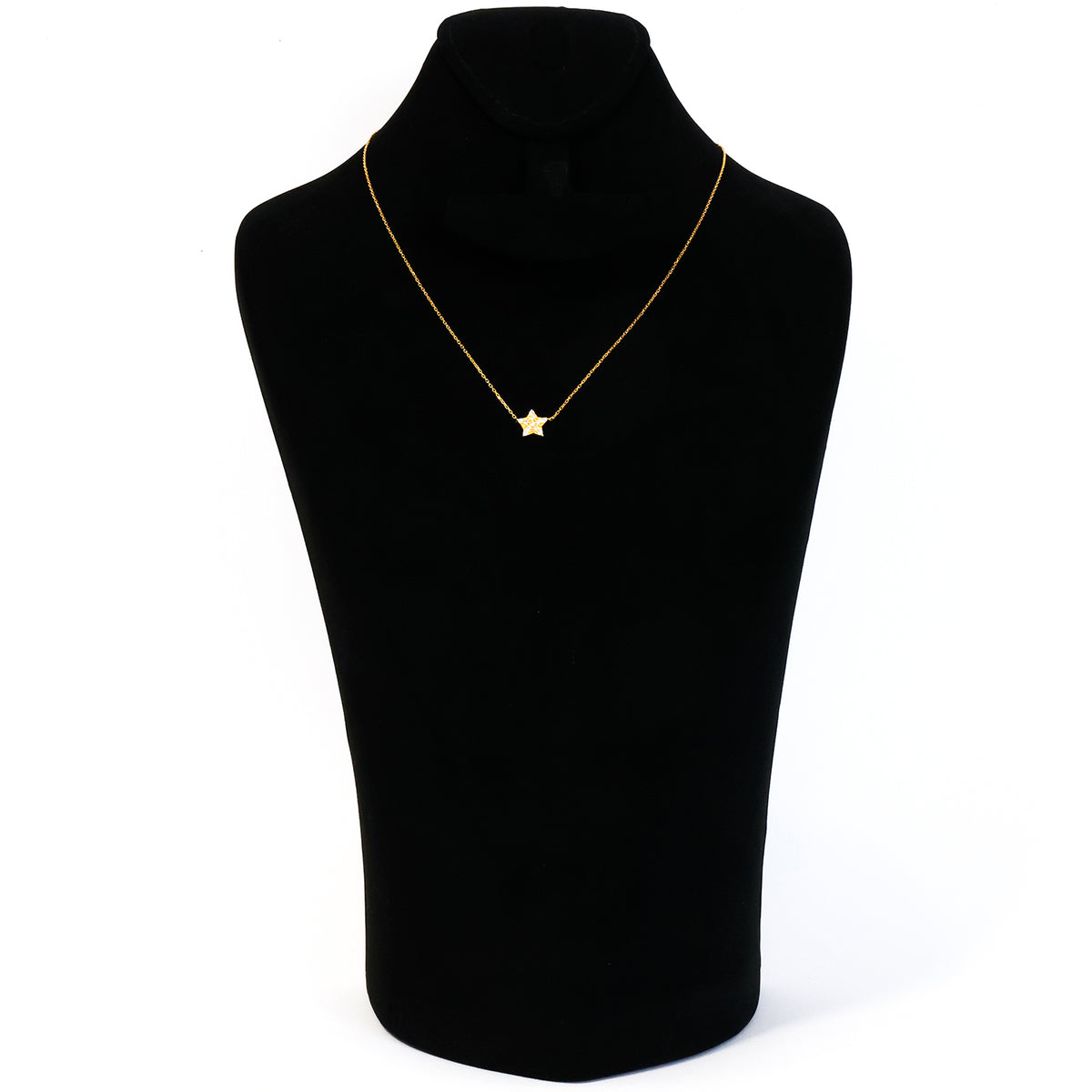 Gold star necklace on a black mannequin bust against a white background