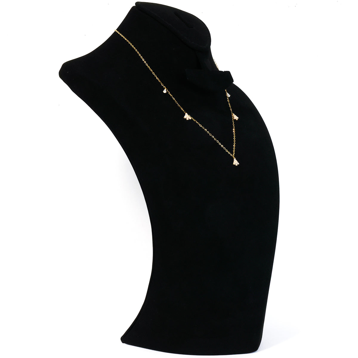 Gold necklace with a pendant on a black mannequin bust against a white background