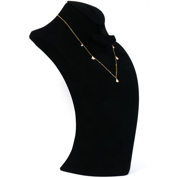 Gold necklace with a pendant on a black mannequin bust against a white background