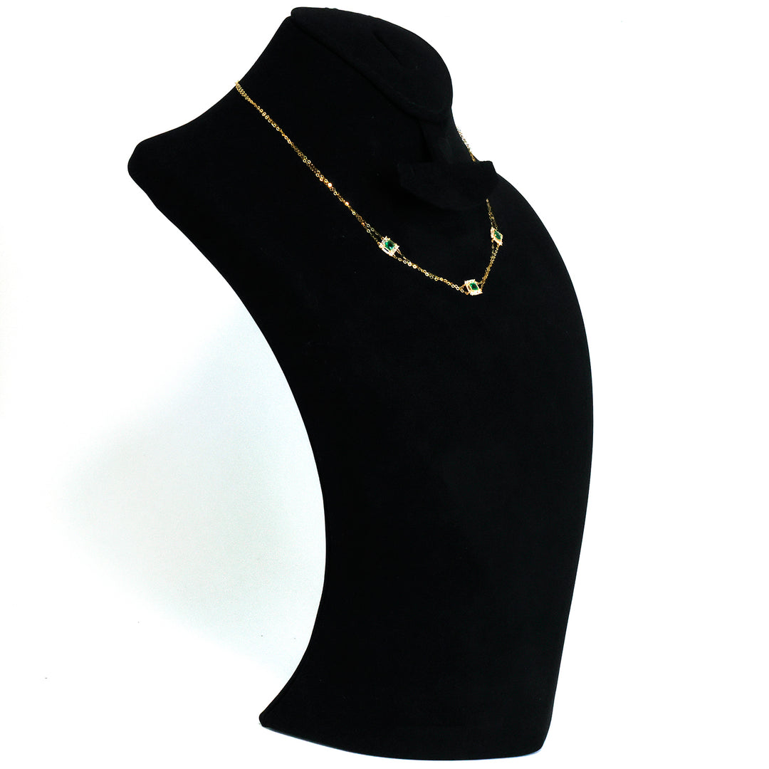 Pearl necklace on a black mannequin bust against a white background