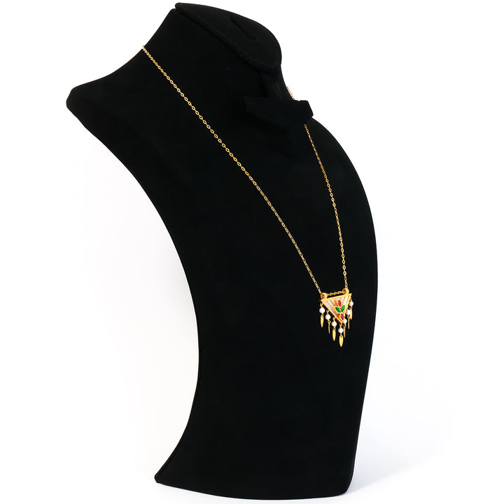 Black turtleneck with gold necklace and 'ANATOL' pendant on a white background