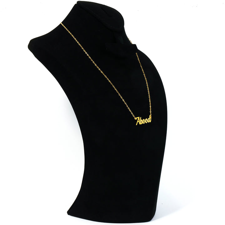 Gold necklace with 'Aboud' pendant on a black mannequin bust.
