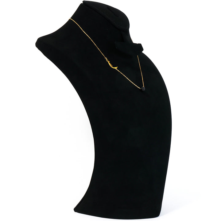 Black garment with a gold neckline on a white background