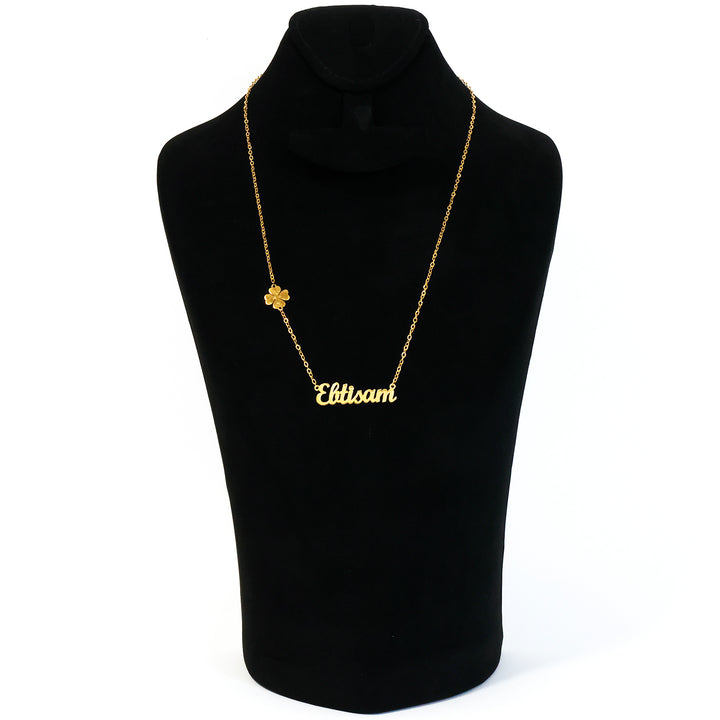 Gold necklace with 'Elbisam' pendant on a black mannequin bust.