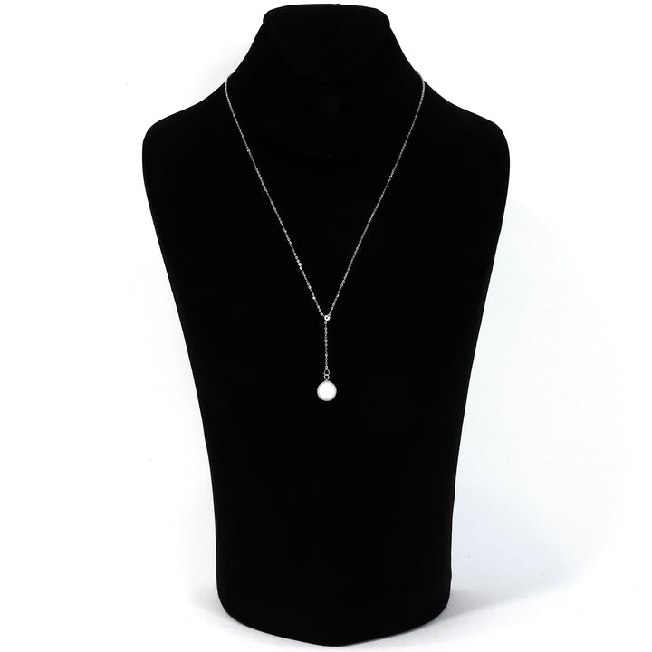 Necklace with a pendant on a black mannequin bust against a white background