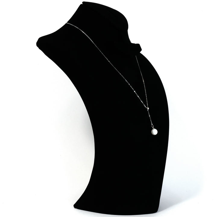 Black mannequin neck with a necklace on a white background