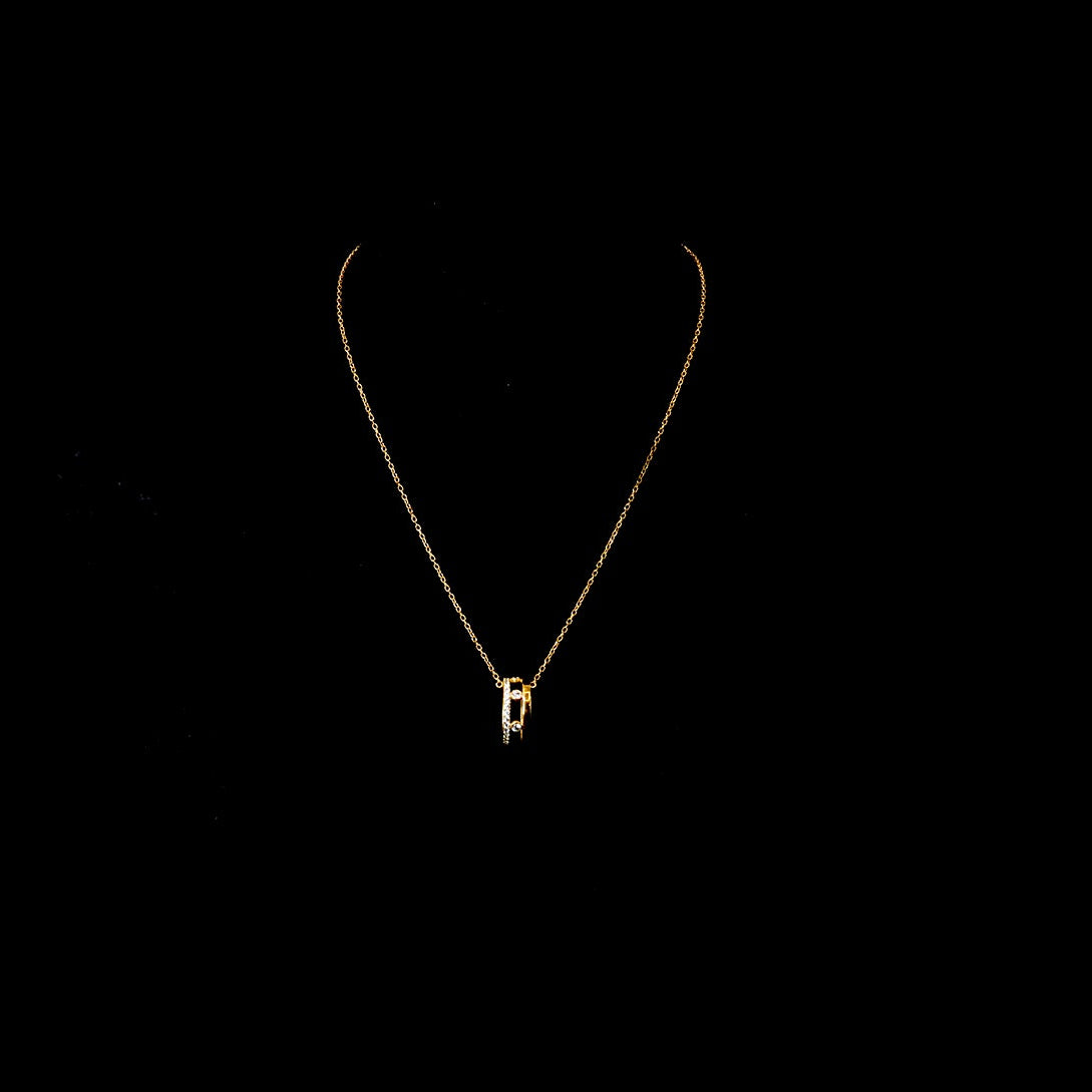 Gold necklace with a small pendant on a black background