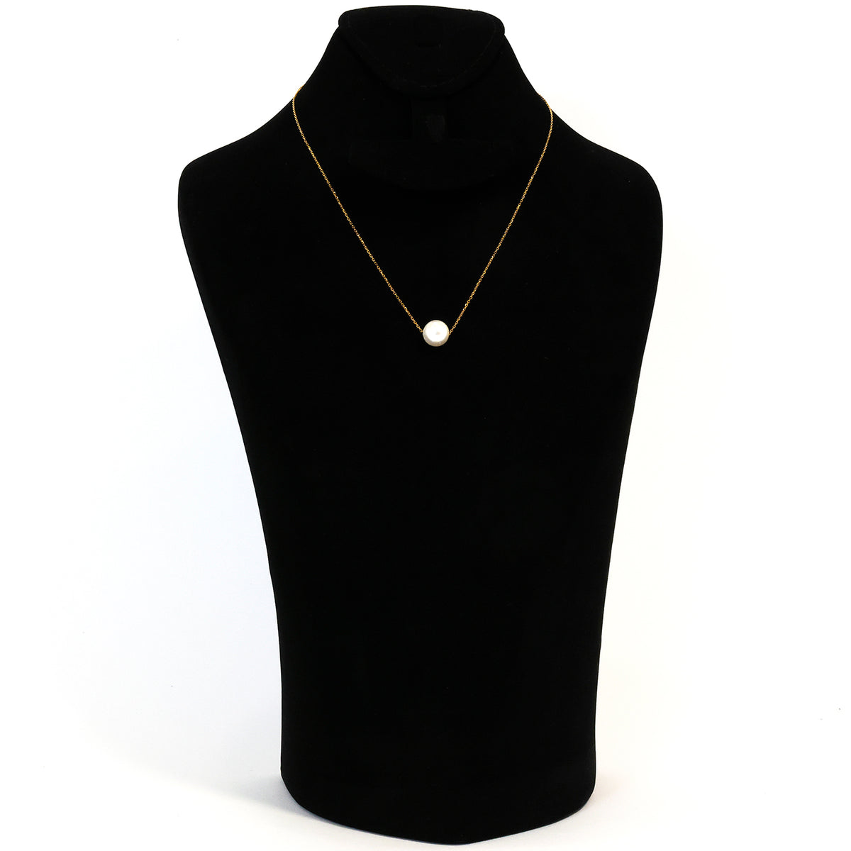 Necklace with a single pearl pendant on a black mannequin bust against a white background