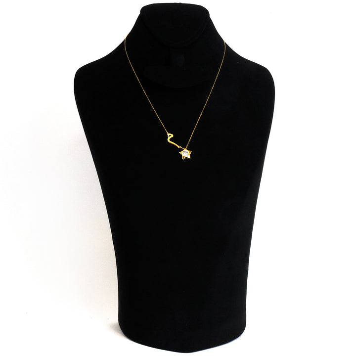 Gold necklace on a black mannequin bust against a white background