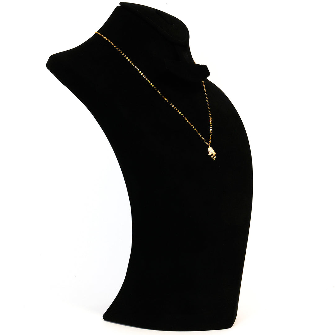 Black turtleneck garment with a gold necklace on a white background