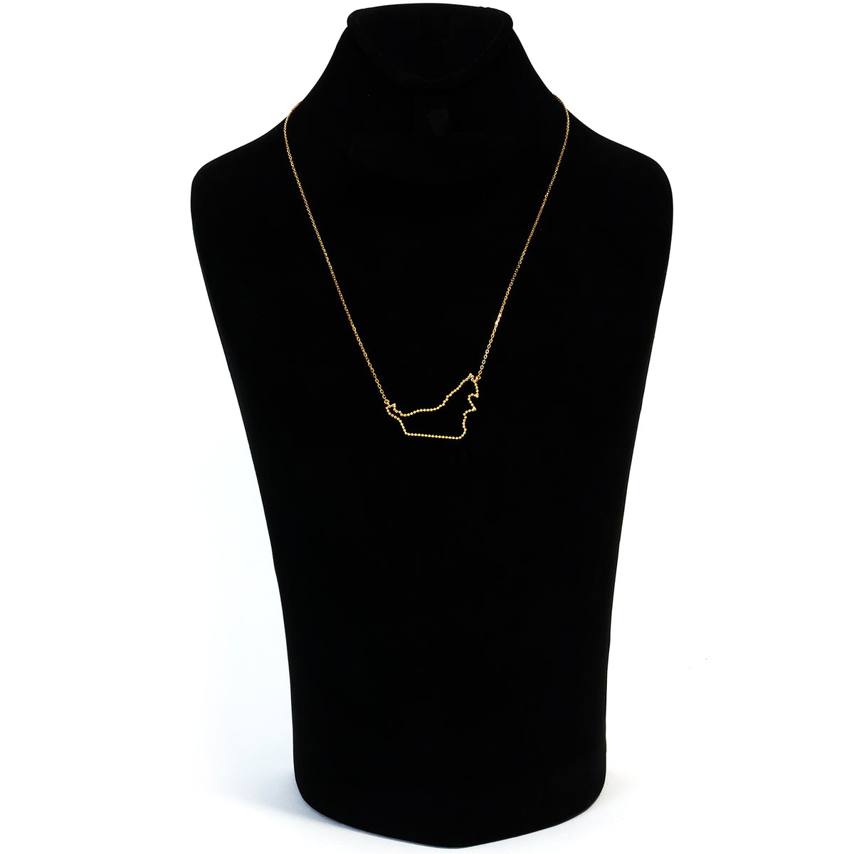 Gold necklace on a black mannequin bust against a white background