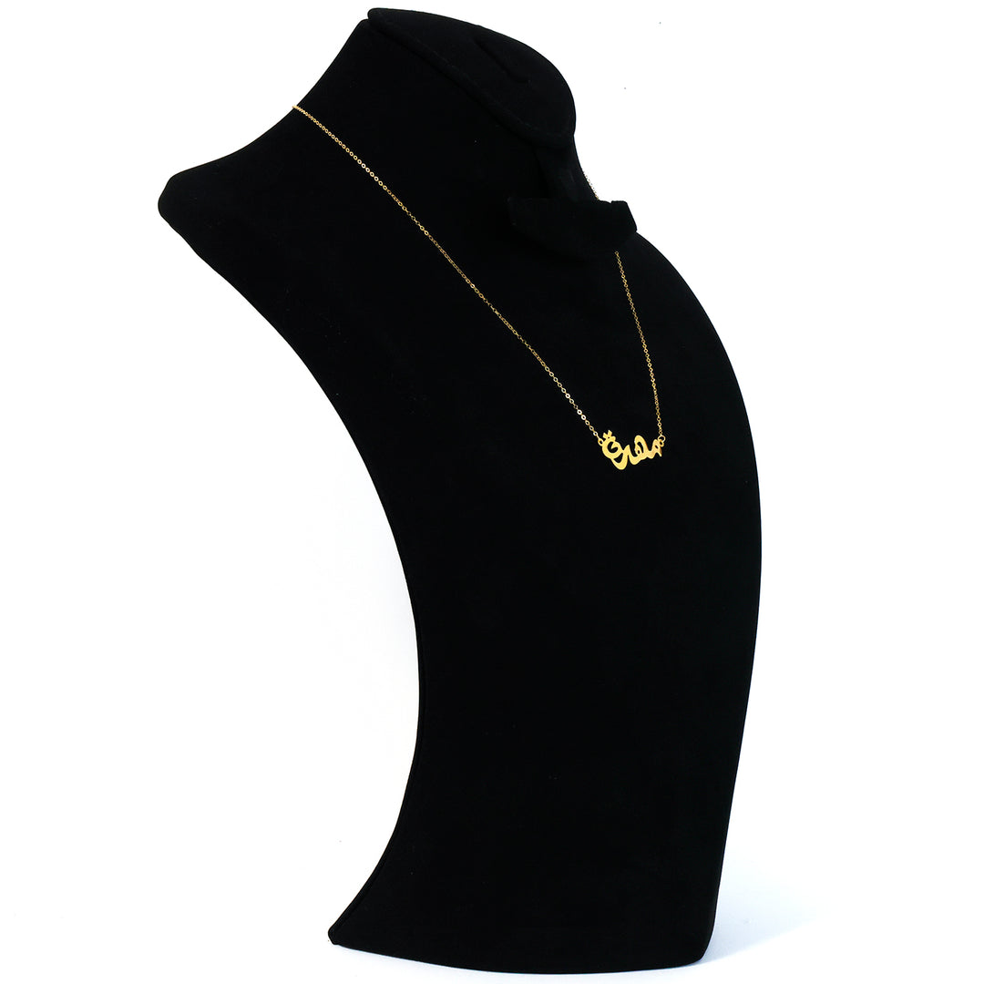 Gold necklace with a pendant on a black mannequin bust against a white background