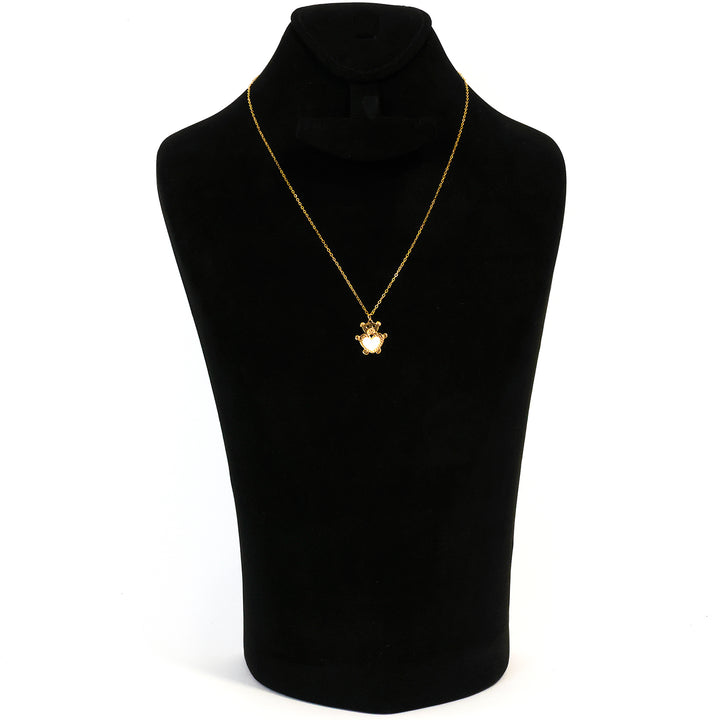 Gold necklace on a black mannequin bust with a white background