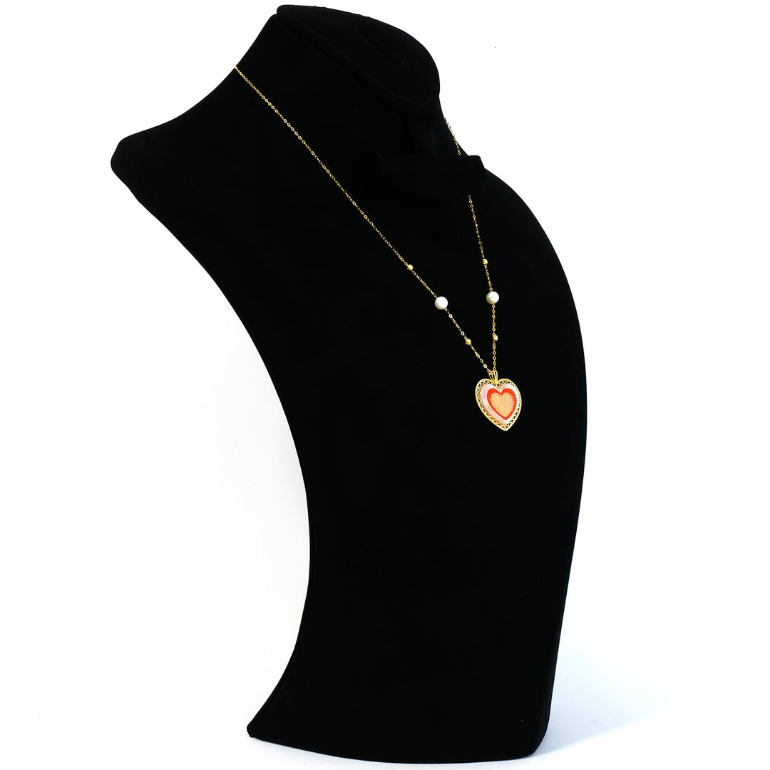 Heart-shaped pendant necklace on a black mannequin bust with a white background