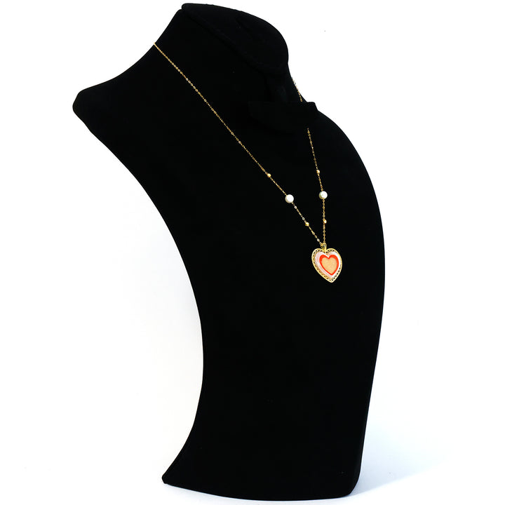 Heart-shaped pendant necklace on a black mannequin bust with a white background