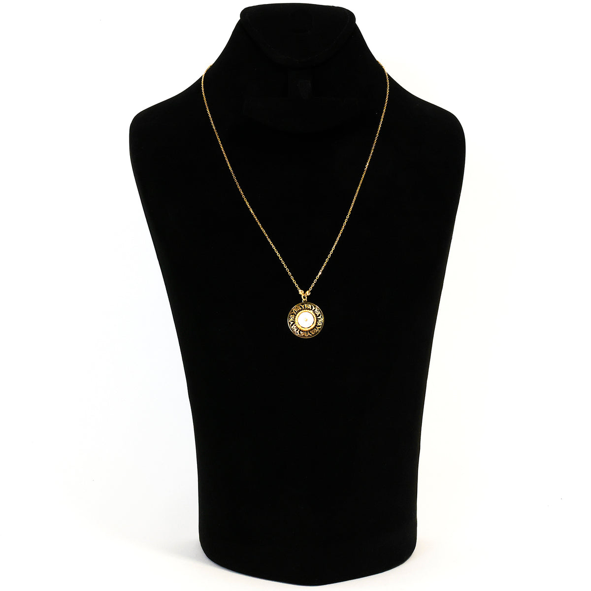 Gold necklace with a pendant on a black mannequin bust against a white background