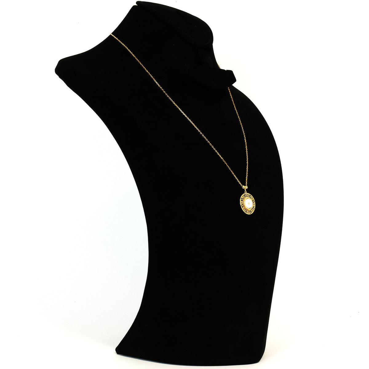 Gold necklace with a pendant on a black mannequin bust against a white background