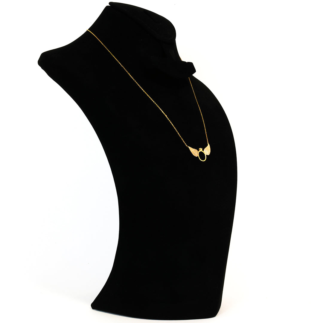 Black velvet stand with a gold necklace on a white background