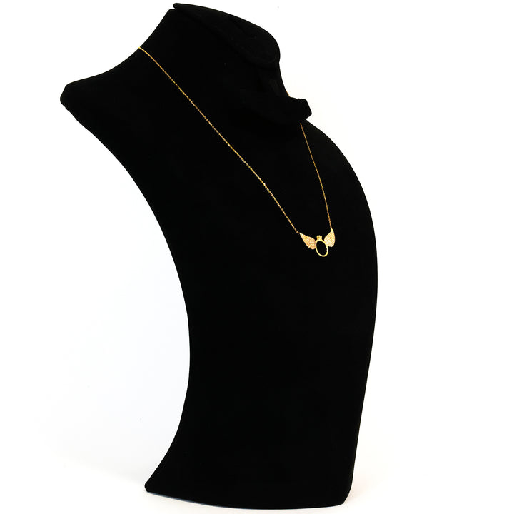 Black velvet stand with a gold necklace on a white background