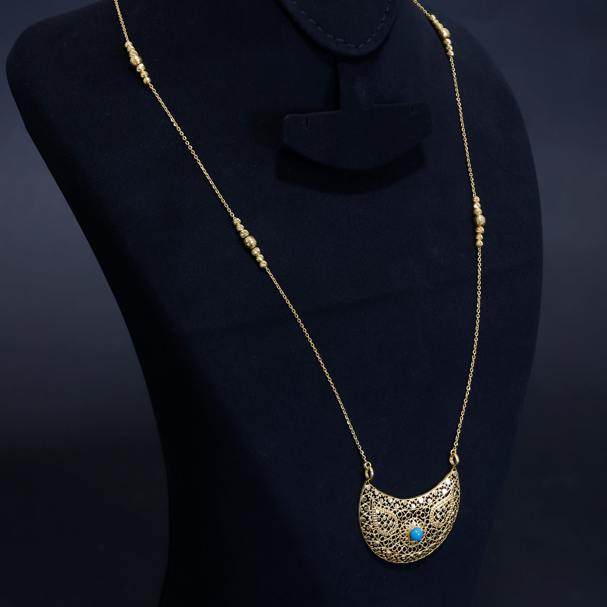 21K gold necklace with intricate filigree work and a blue stone pendant – Side Angle