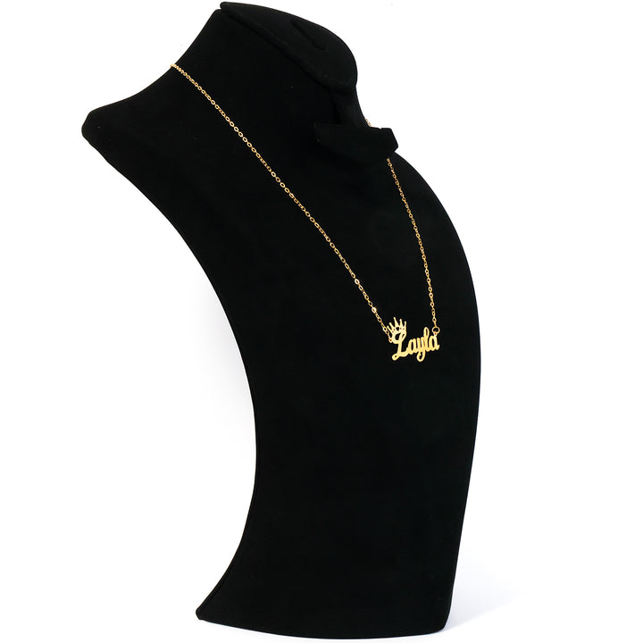 Black turtleneck with gold necklace and 'ANATOL' pendant on a white background
