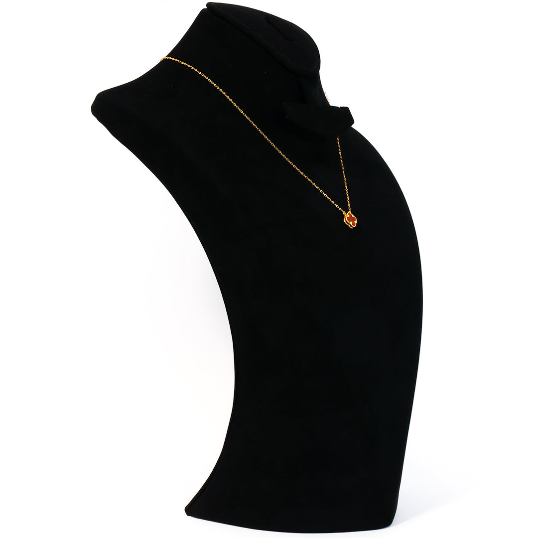 Black turtleneck sweater with a gold necklace on a white background