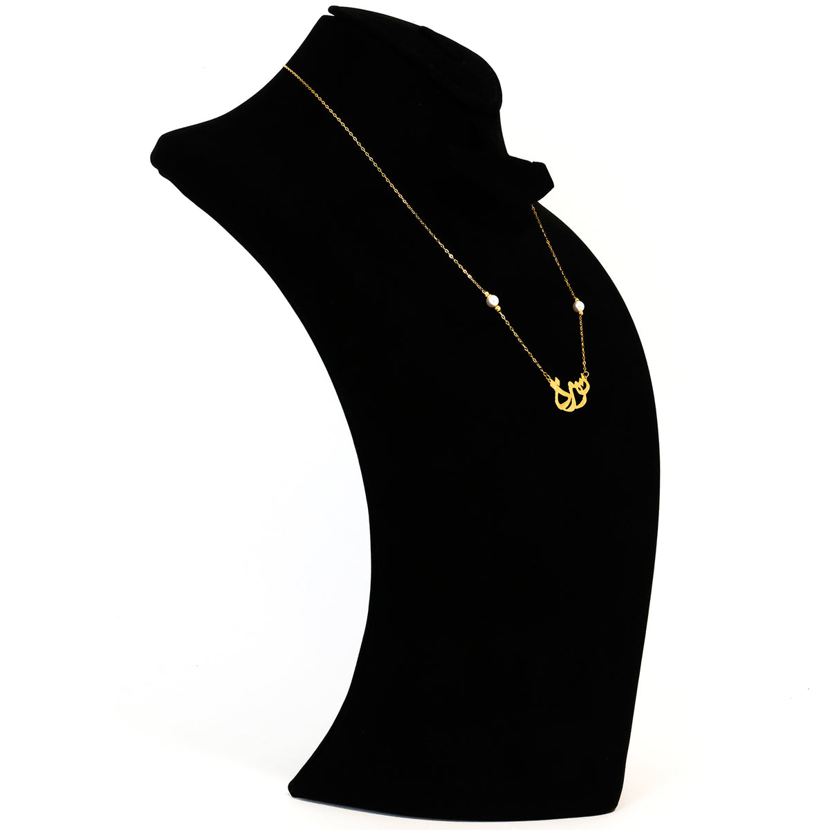 Gold necklace on a black mannequin bust against a white background
