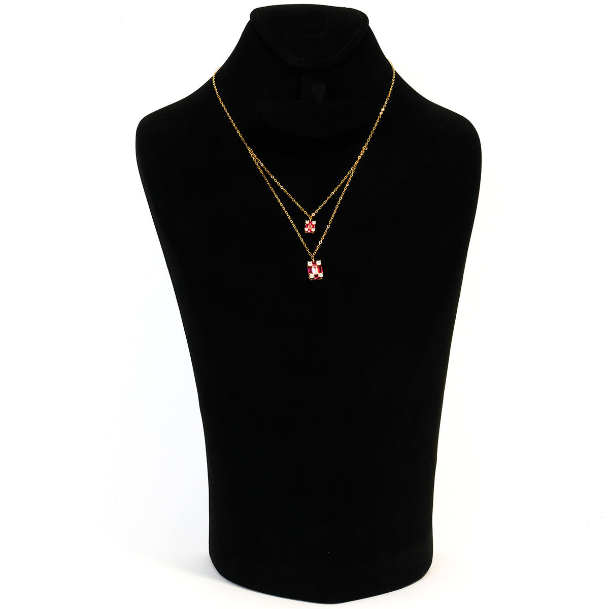Gold necklace with a pendant on a black mannequin bust against a white background