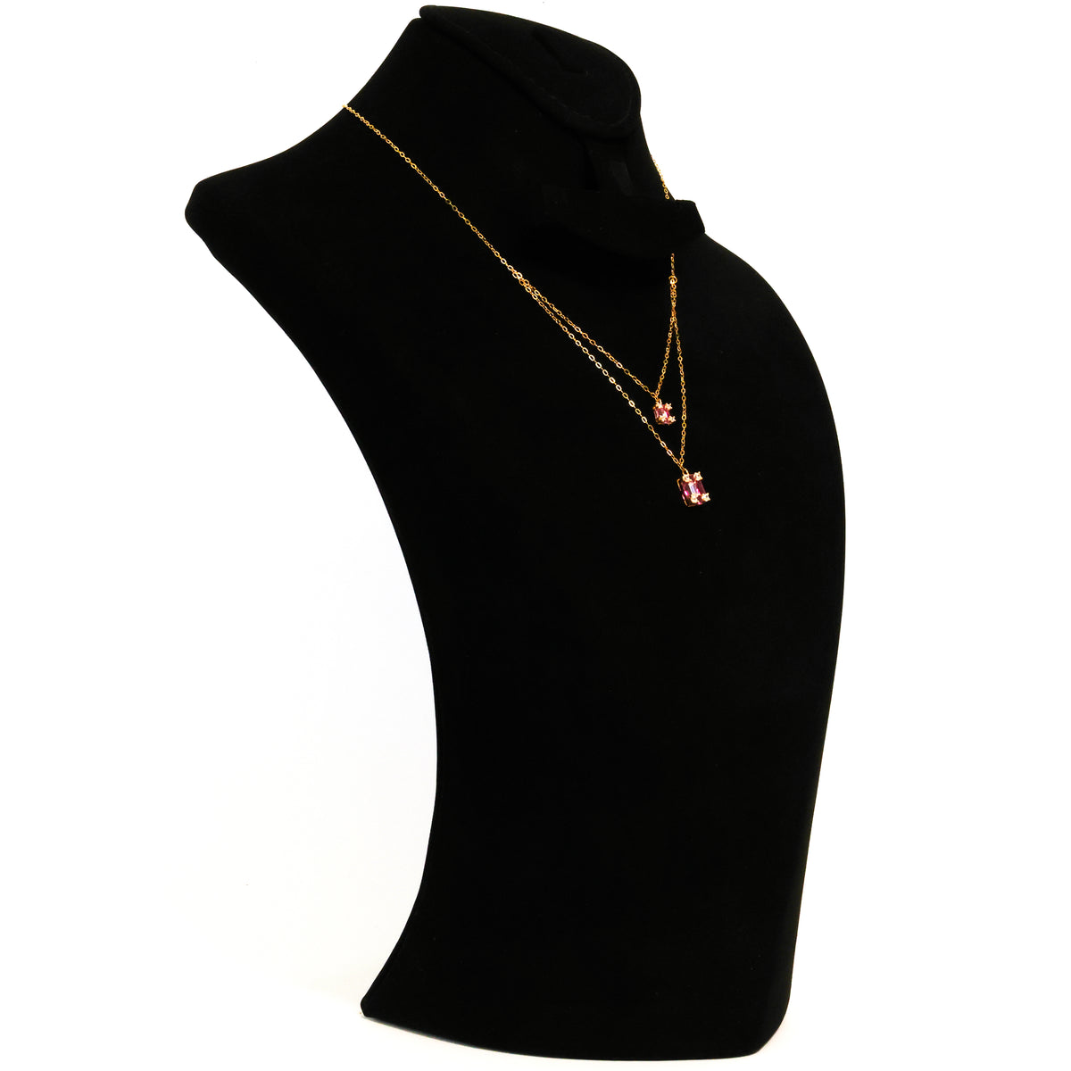Gold necklace with a heart-shaped pendant on a black mannequin bust.