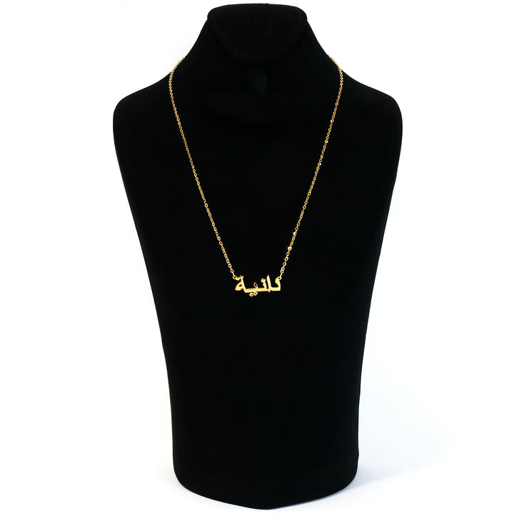 Black turtleneck sweater with a gold chain necklace on a mannequin against a white background