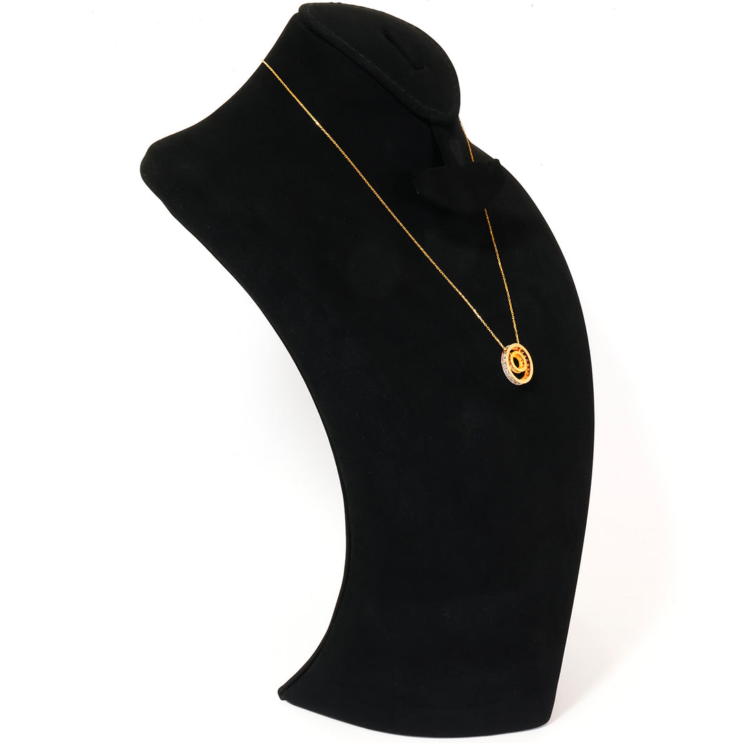Black mannequin neck with a gold necklace on a white background
