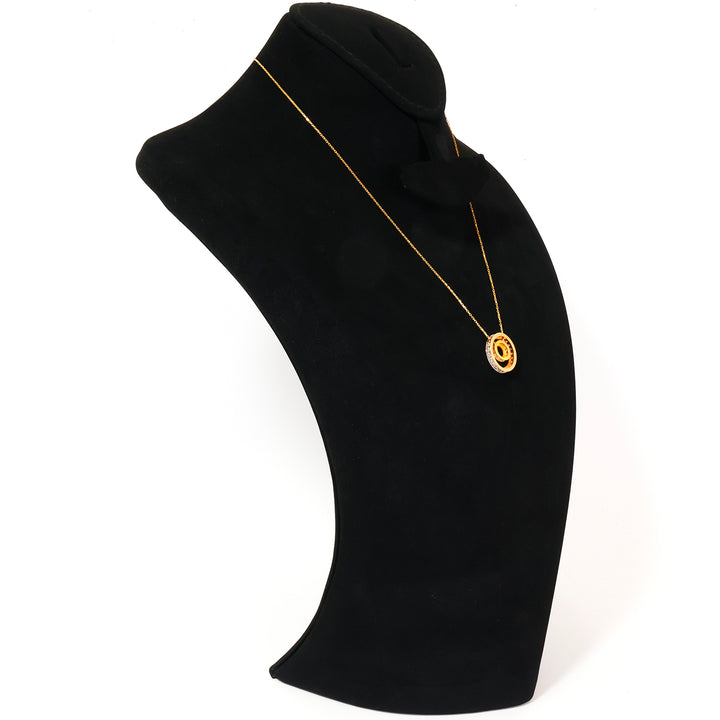 Black mannequin neck with a gold necklace on a white background