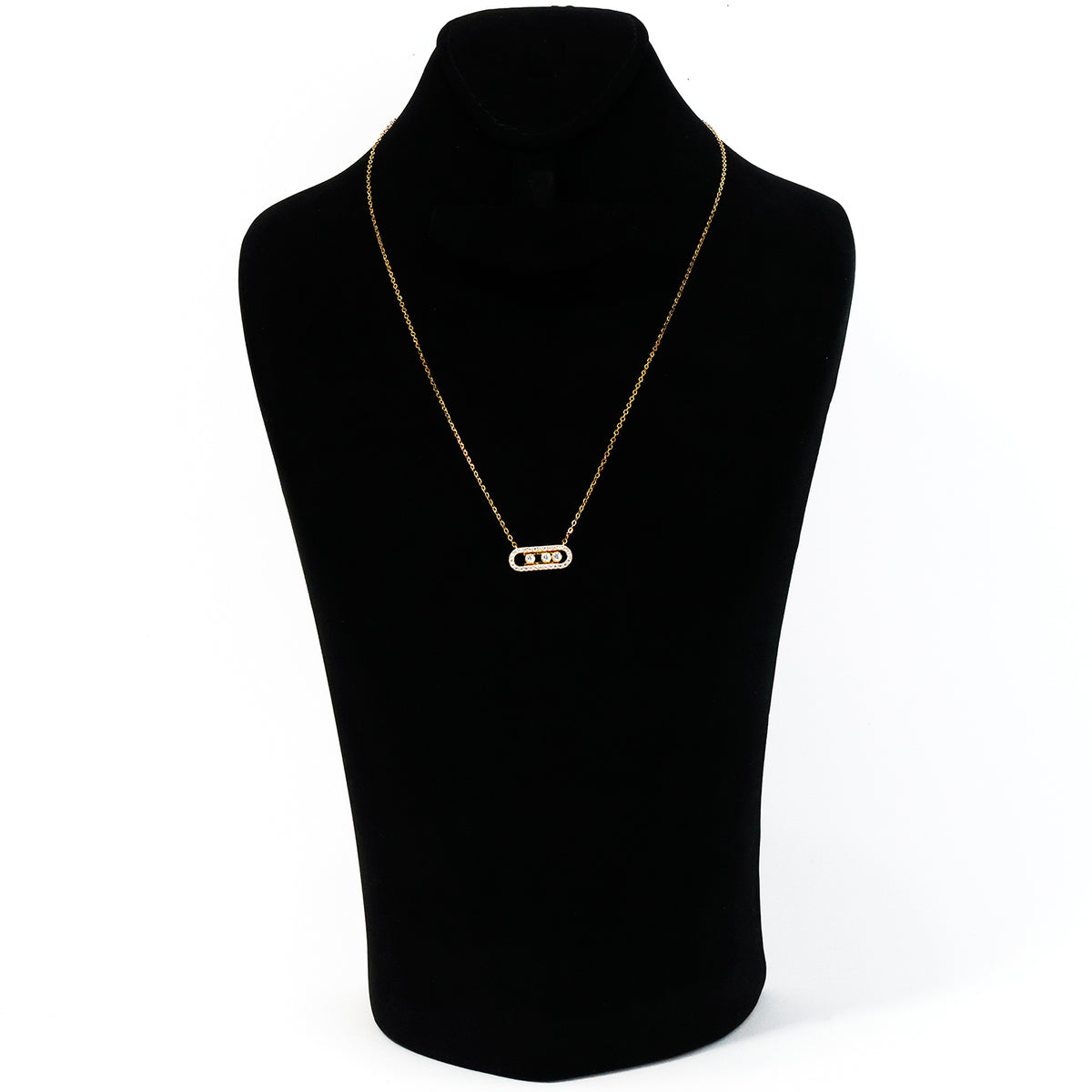Gold necklace on a black mannequin bust against a white background