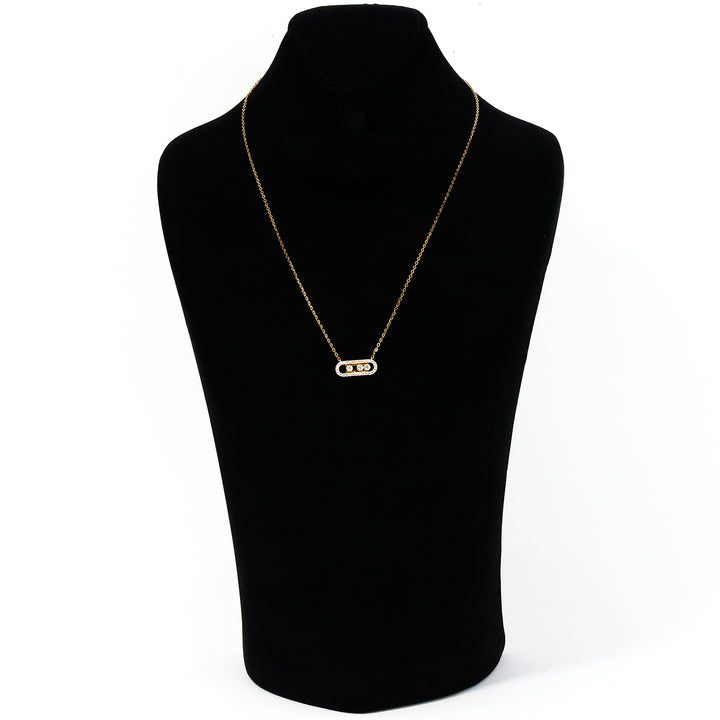 Gold necklace on a black mannequin bust against a white background