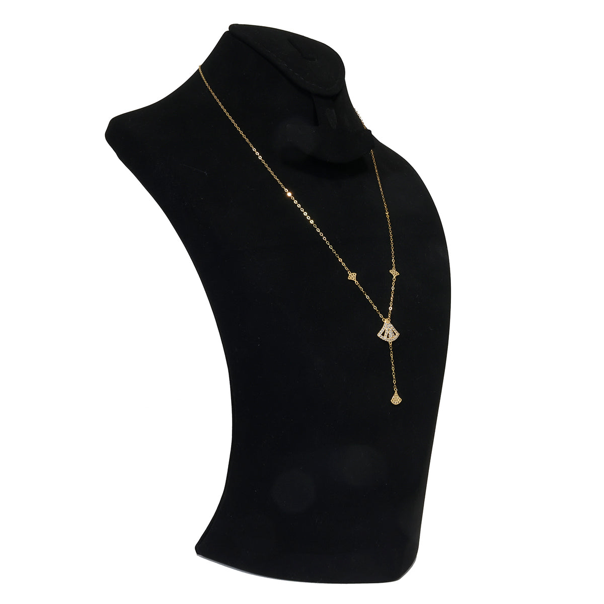 Gold necklace on a black mannequin bust against a white background