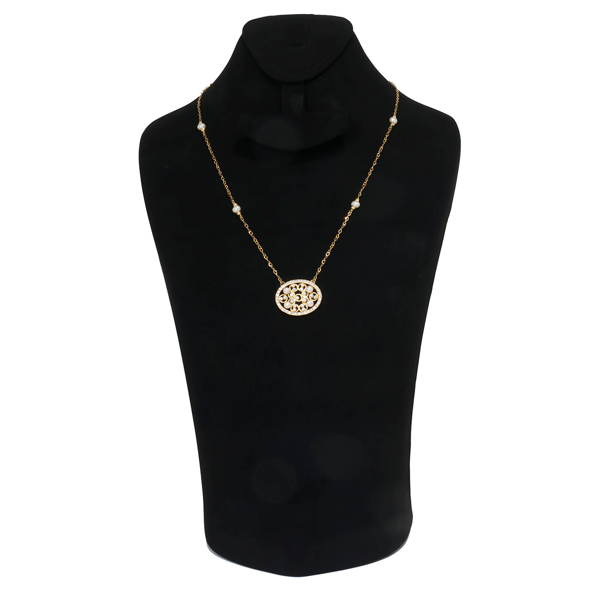 Gold necklace on a black mannequin bust with a white background