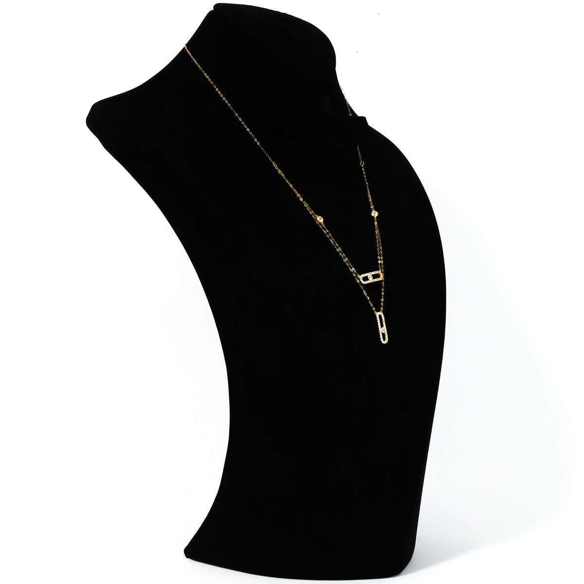 Gold necklace on a black mannequin bust against a white background