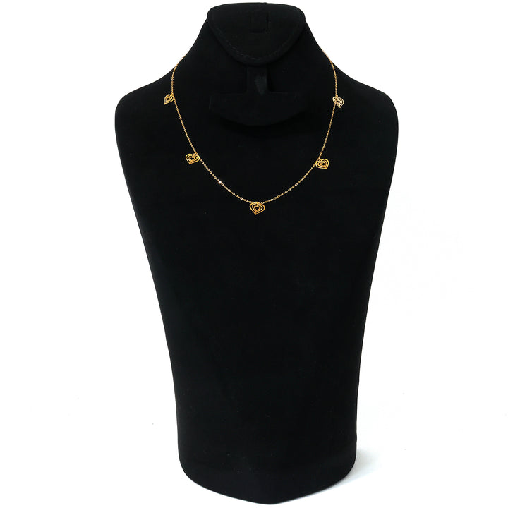 Gold necklace on a black mannequin with a white background