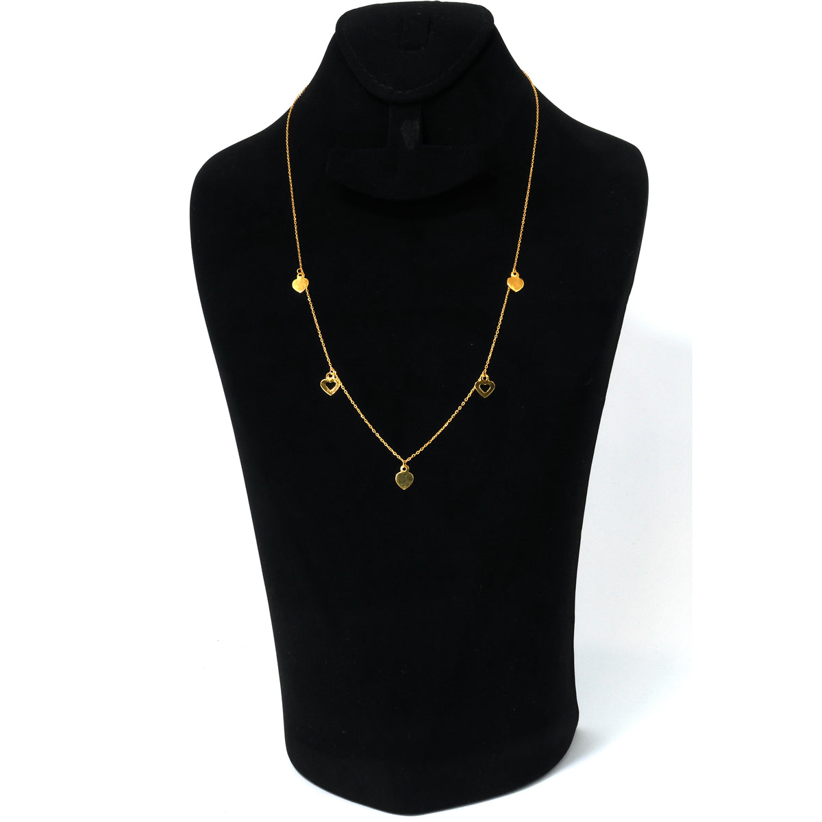 Gold necklace on a black mannequin with a white background