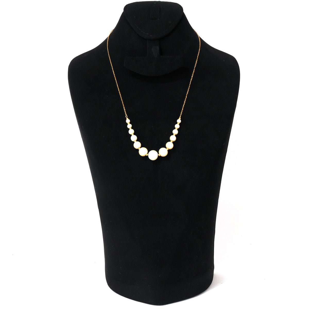 Pearl necklace on a black mannequin with a white background