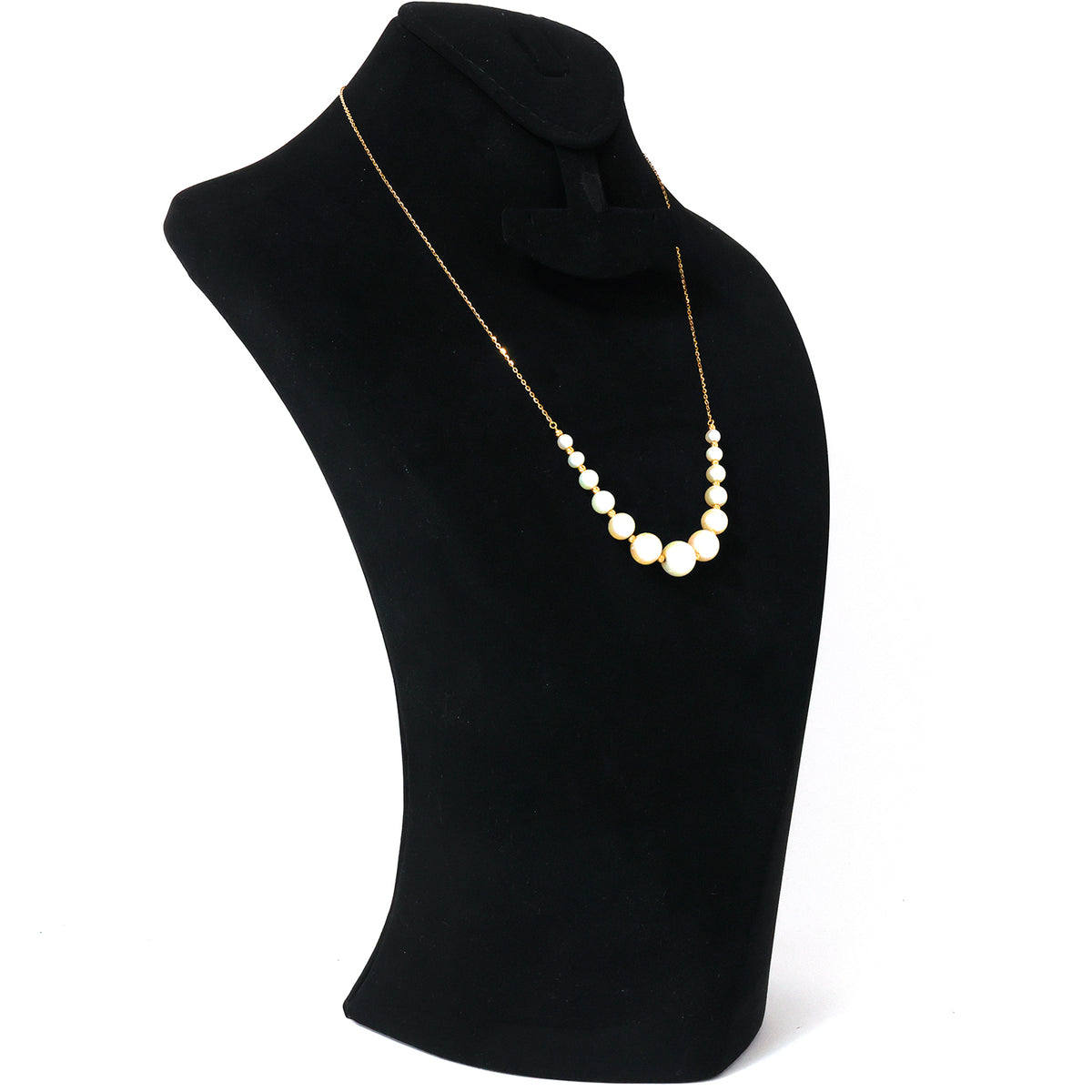 Pearl necklace on a black mannequin bust against a white background