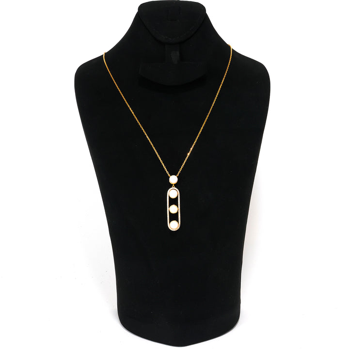 Gold necklace with a pendant on a black mannequin bust.