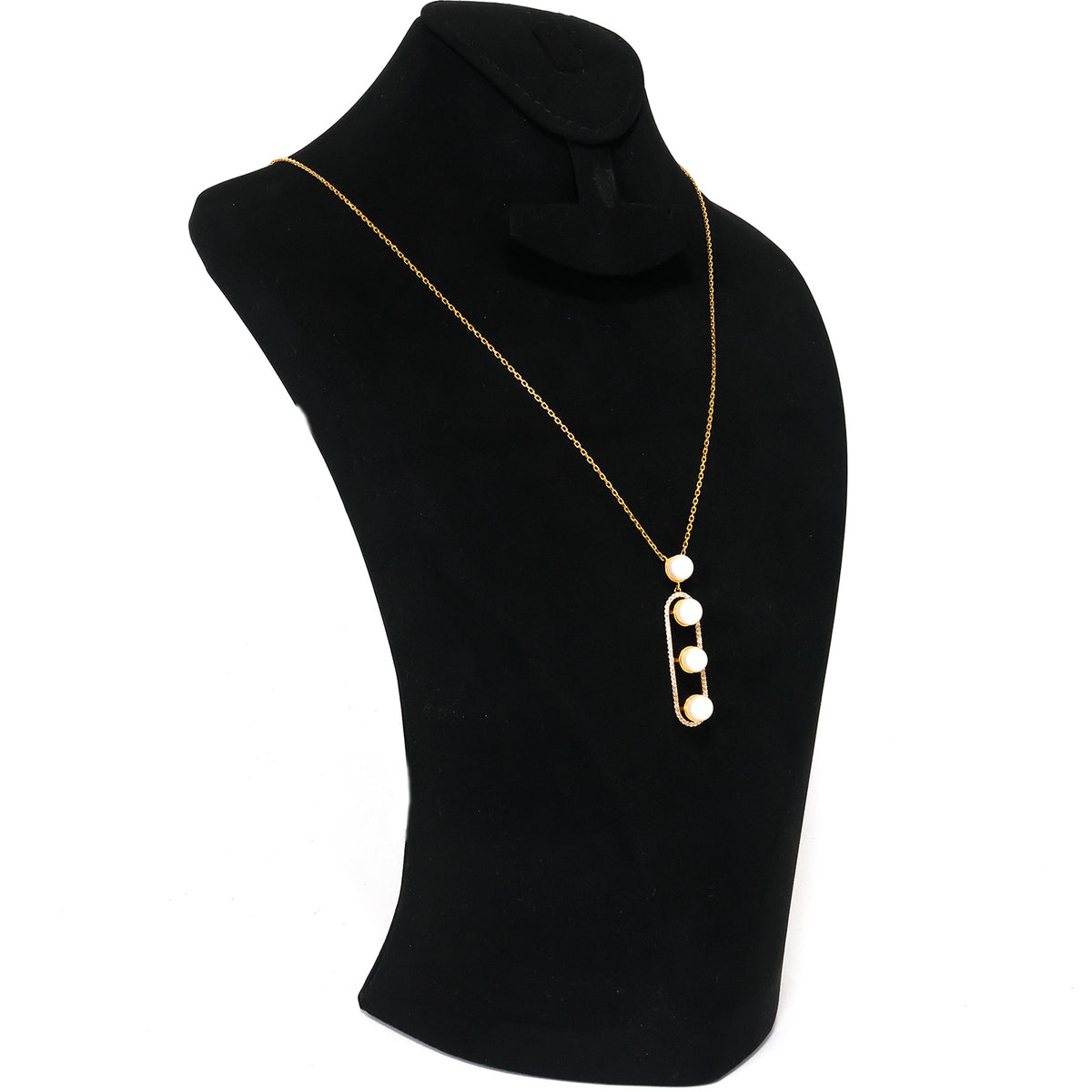 Gold necklace with three pearl pendants on a black mannequin bust.