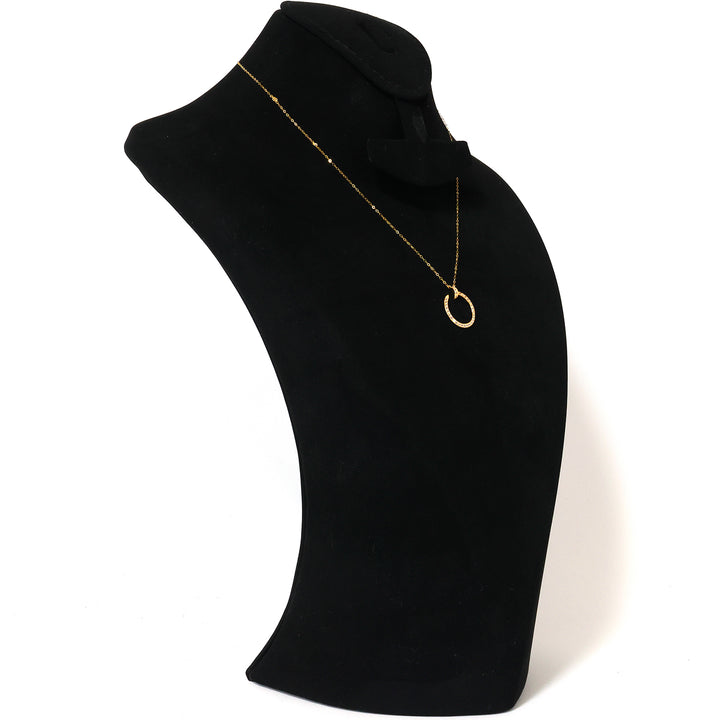 Black turtleneck sweater with a gold necklace on a white background