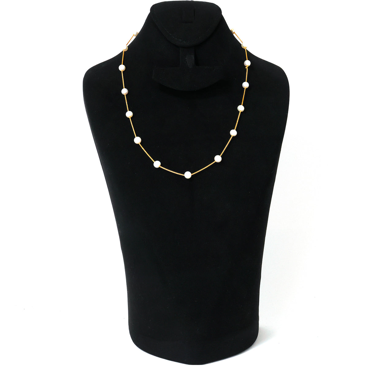 Necklace with white beads on a black mannequin bust against a white background