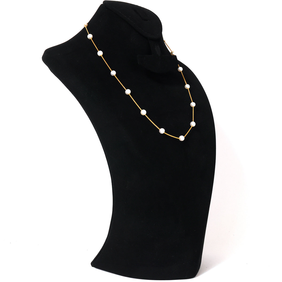 Pearl necklace on a black mannequin bust against a white background