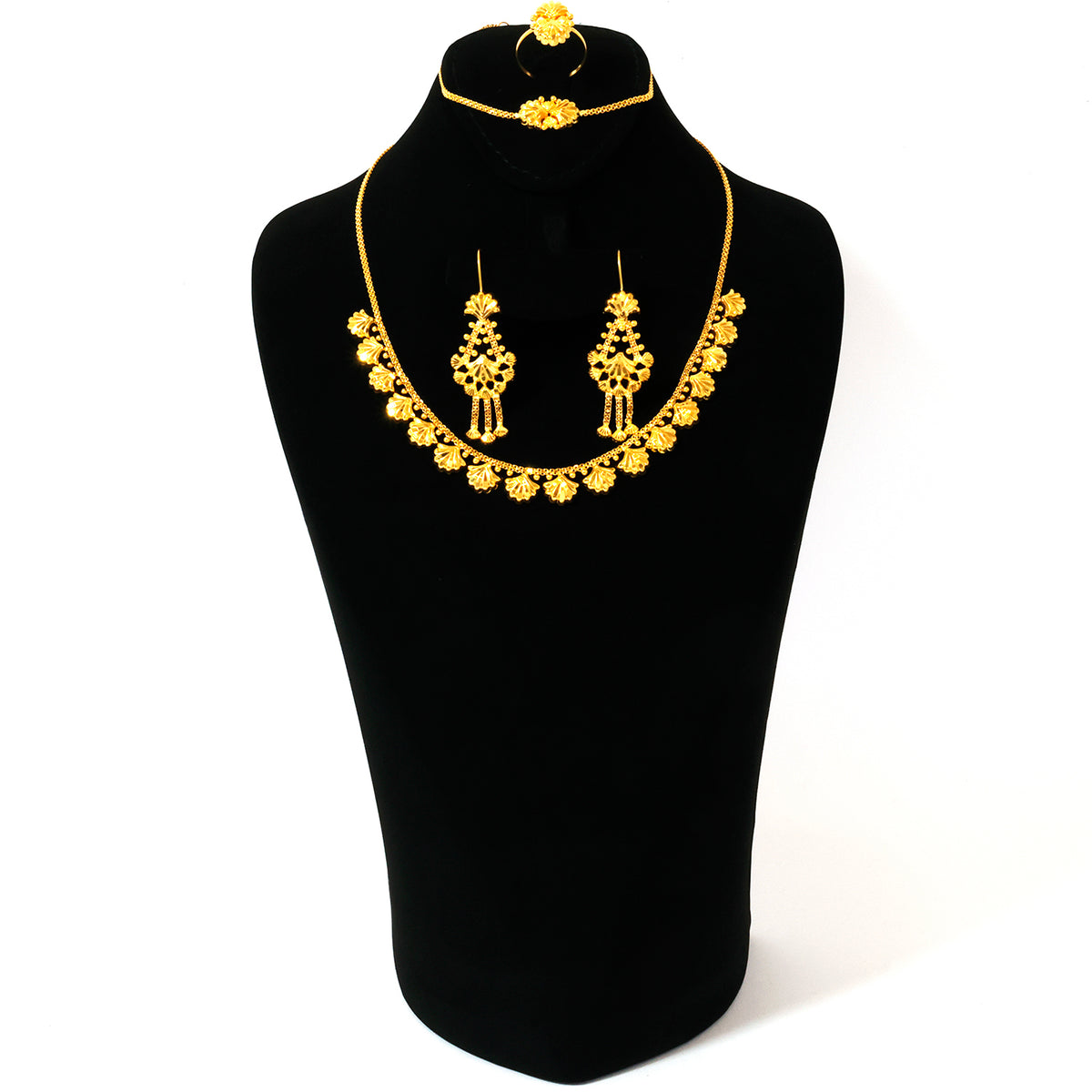 Gold jewelry set on a black mannequin bust with a white background