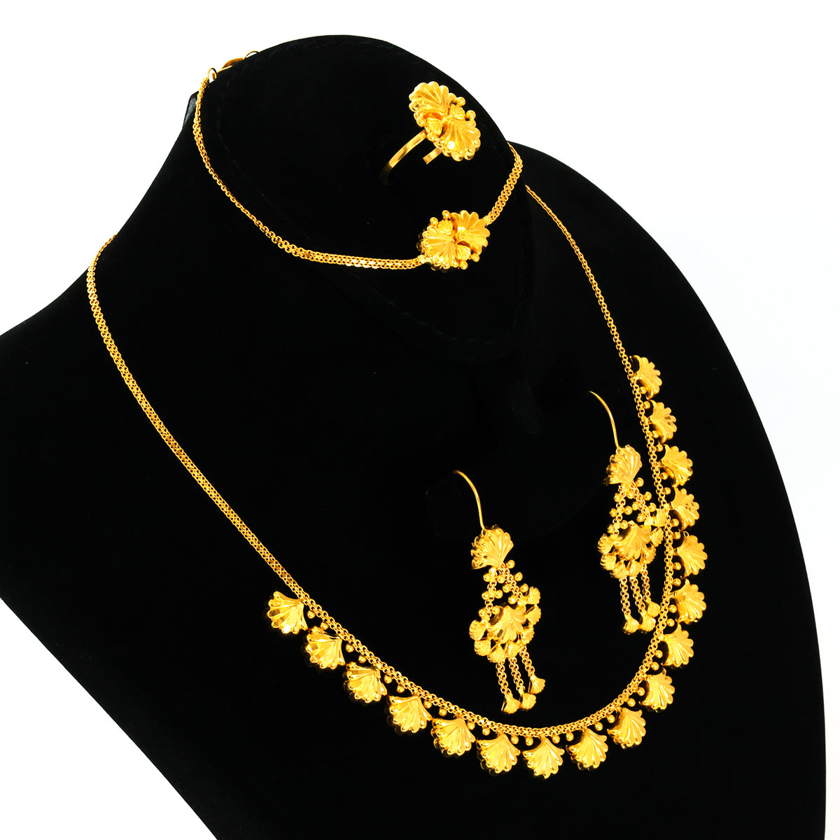 Gold necklace and earrings set on a black mannequin bust with a white background