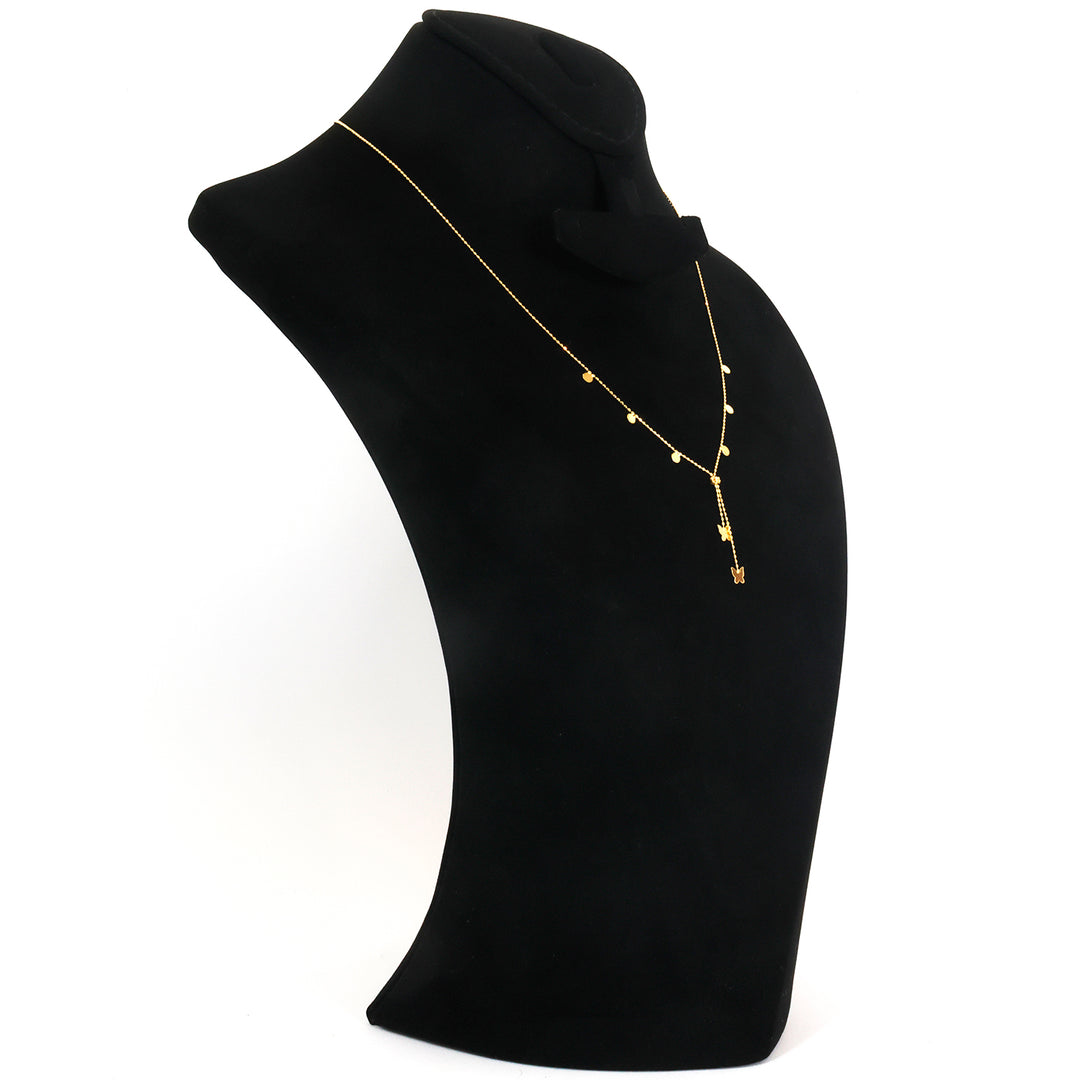 Gold necklace with a pendant on a black mannequin bust against a white background